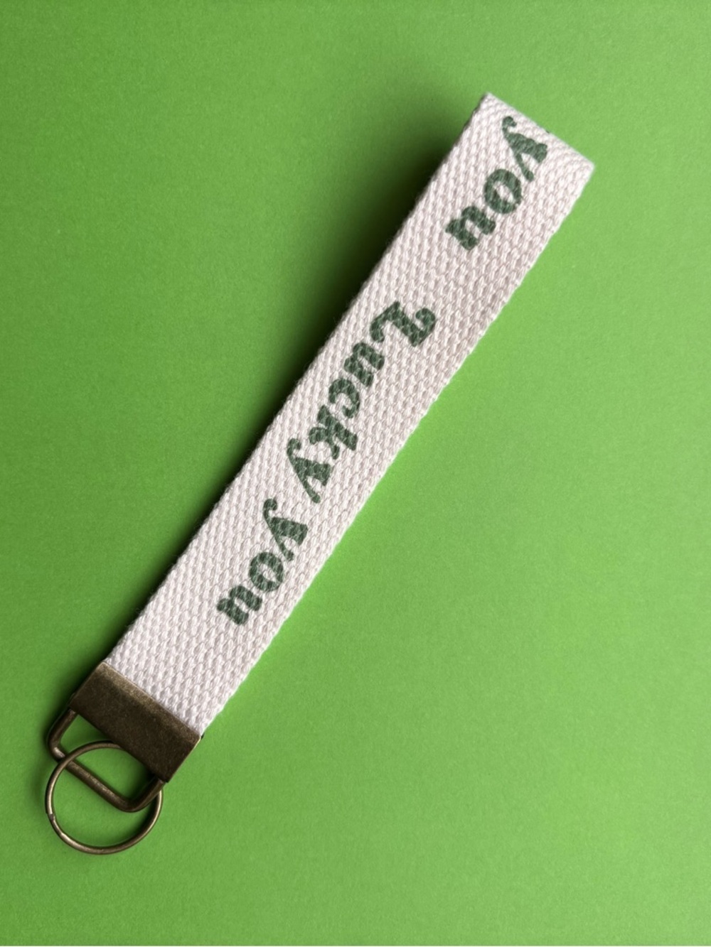 White Canvas Key Fob Wristlet with Green Text “lucky you”